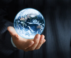 holding a glowing earth globe in his hands